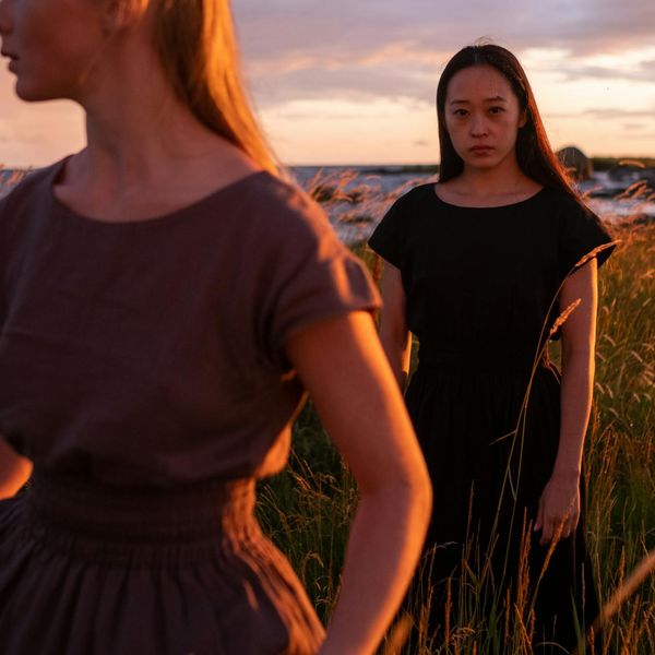Silhouette of a person in a meditative pose against a sunset.